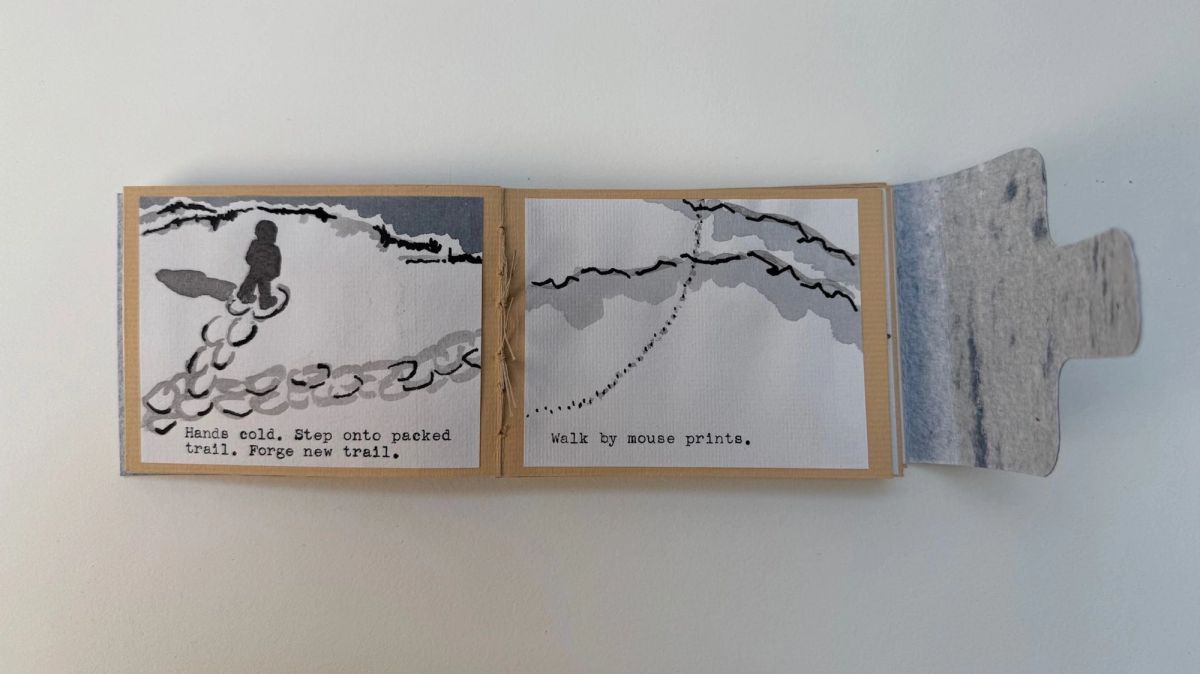 A spread from the same book. A dark figure walks a trail of looping snowshoe prints on the left; a bare branch and a dotted line of tracks on the right. Typed lines read "Hands cold..." and "Walk by mouse prints."