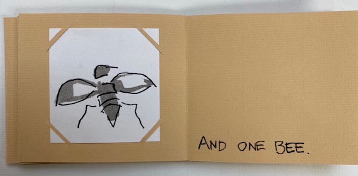 A kraft-card zine spread. A loose grey and black drawing of a bee with outstretched wings is corner-mounted on white; opposite, hand-lettered capitals read "AND ONE BEE."