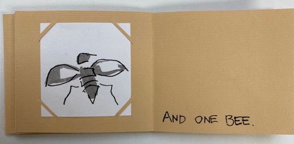 A kraft-card zine spread. A loose grey and black drawing of a bee with outstretched wings is corner-mounted on white; opposite, hand-lettered capitals read "AND ONE BEE."