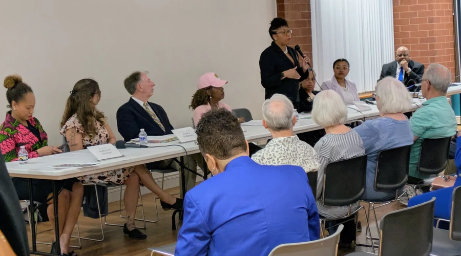 Jade Ranger, co-owner of The Prescription Shoppe, addresses attendees of the forum Voices for Change: Executive Orders & Community Impact on Monday evening