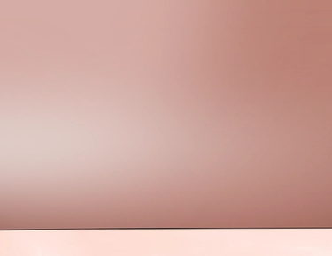 A bottle of Nexxus Epic Shine Anti-Humidity Spray is shown against a rose-gold background.