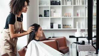Hairstylist advising female customer at a hair salon.