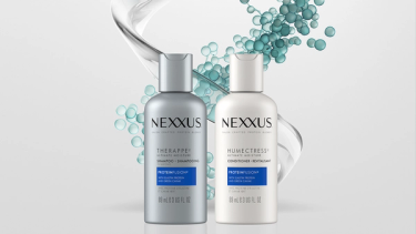 Bottles of Therappe Ultimate Moisture Shampoo and Humectress Ultimate Moisture Conditioner are shown against a white background with droplets and swirls of moisture behind them. ​