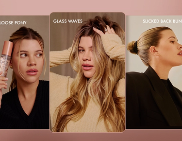 Sofia Richie Grainge poses with her hands in her hair as it cascades down in waves.