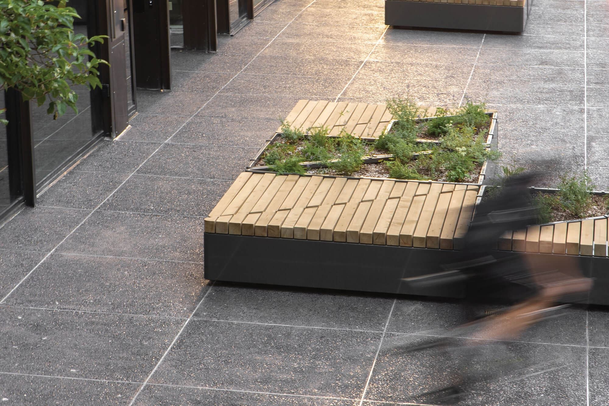 Custom commercial outdoor planter and bench installation with wood.