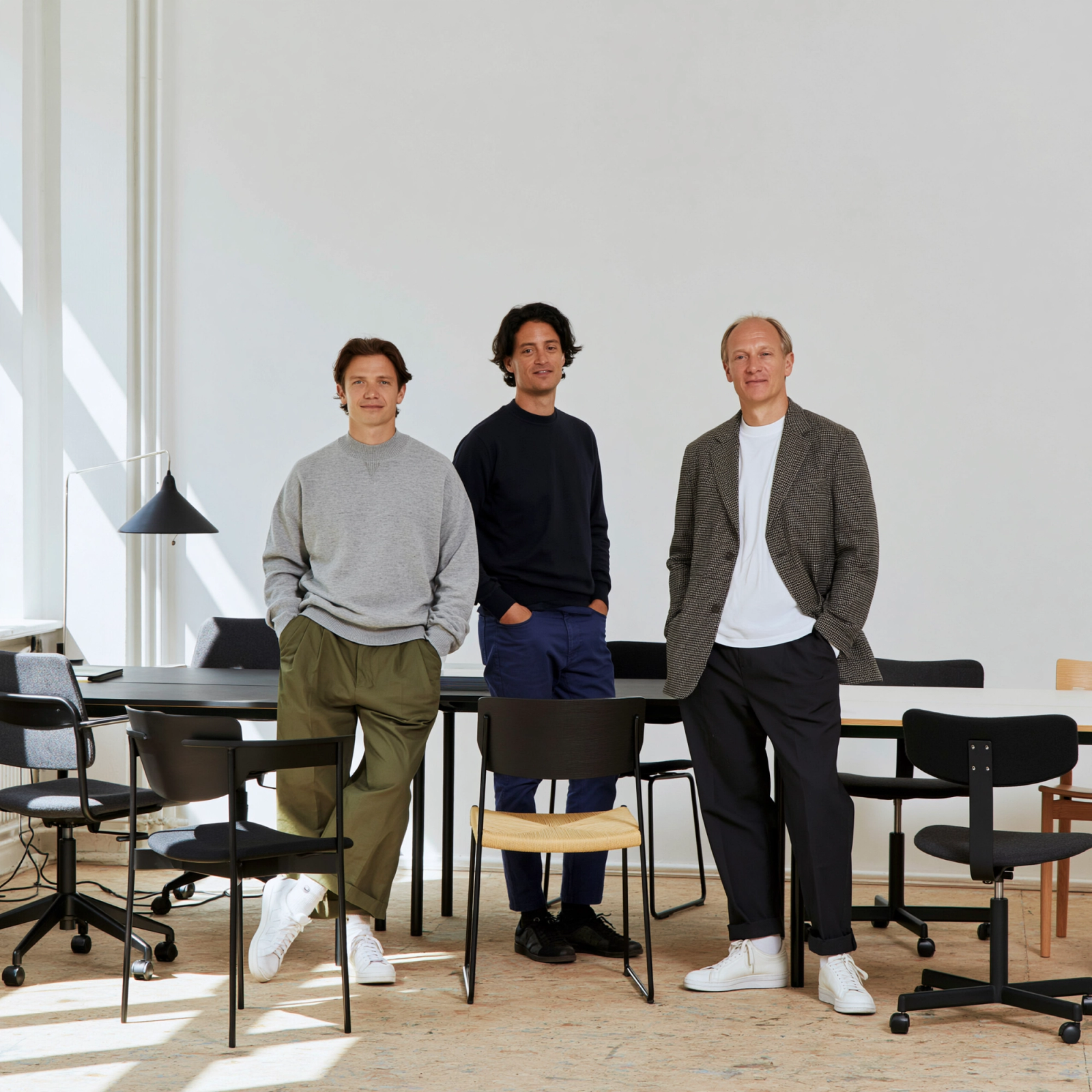 A sustainability team reviewing workplace furniture in a bright office.