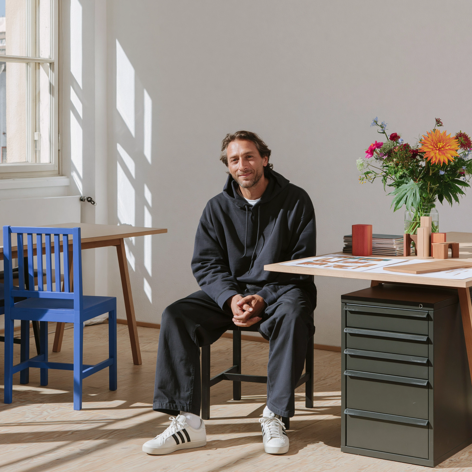 An architect reviewing furniture options for a workspace project.