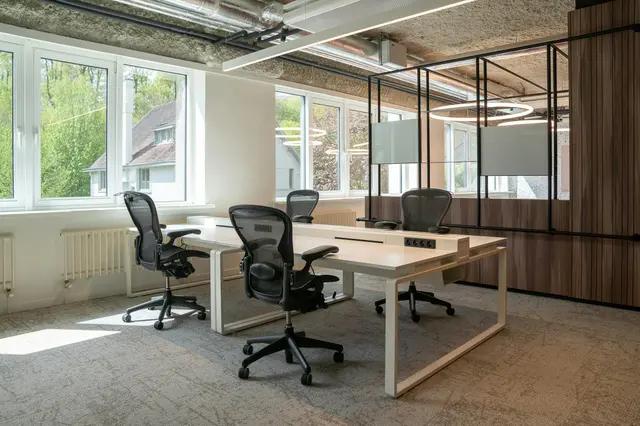 A workspace plan being reviewed with circular office furniture options.