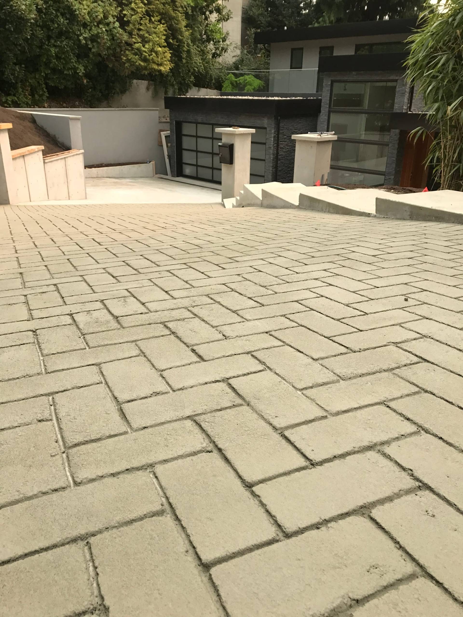Stamped asphalt driveway in stamped asphalt with colour-sealed surface coating at a new-build subdivision, Canada