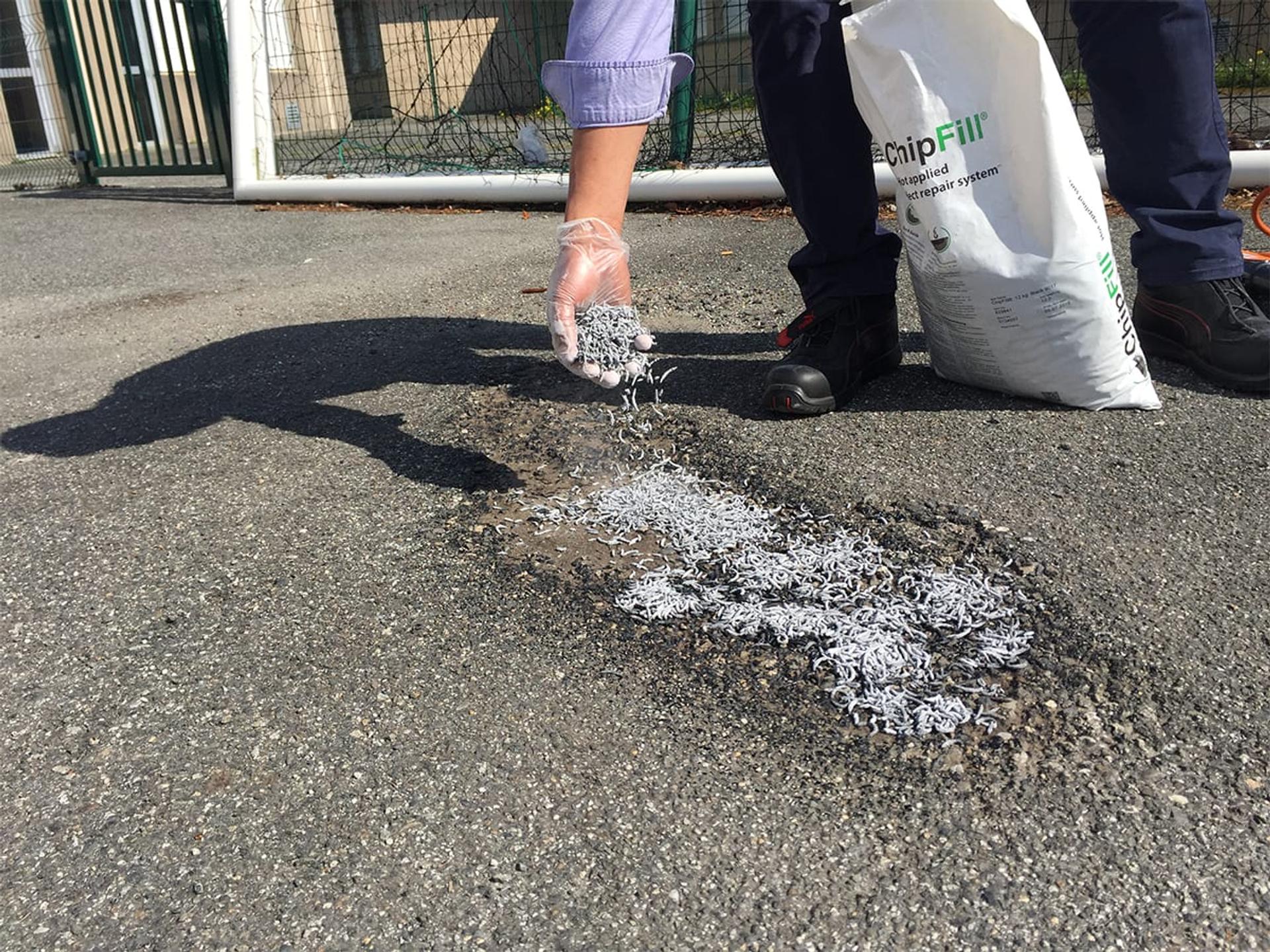 ChipFill pavement repair in aggregate-based pavement repair compound at a parking lot repair, Canada