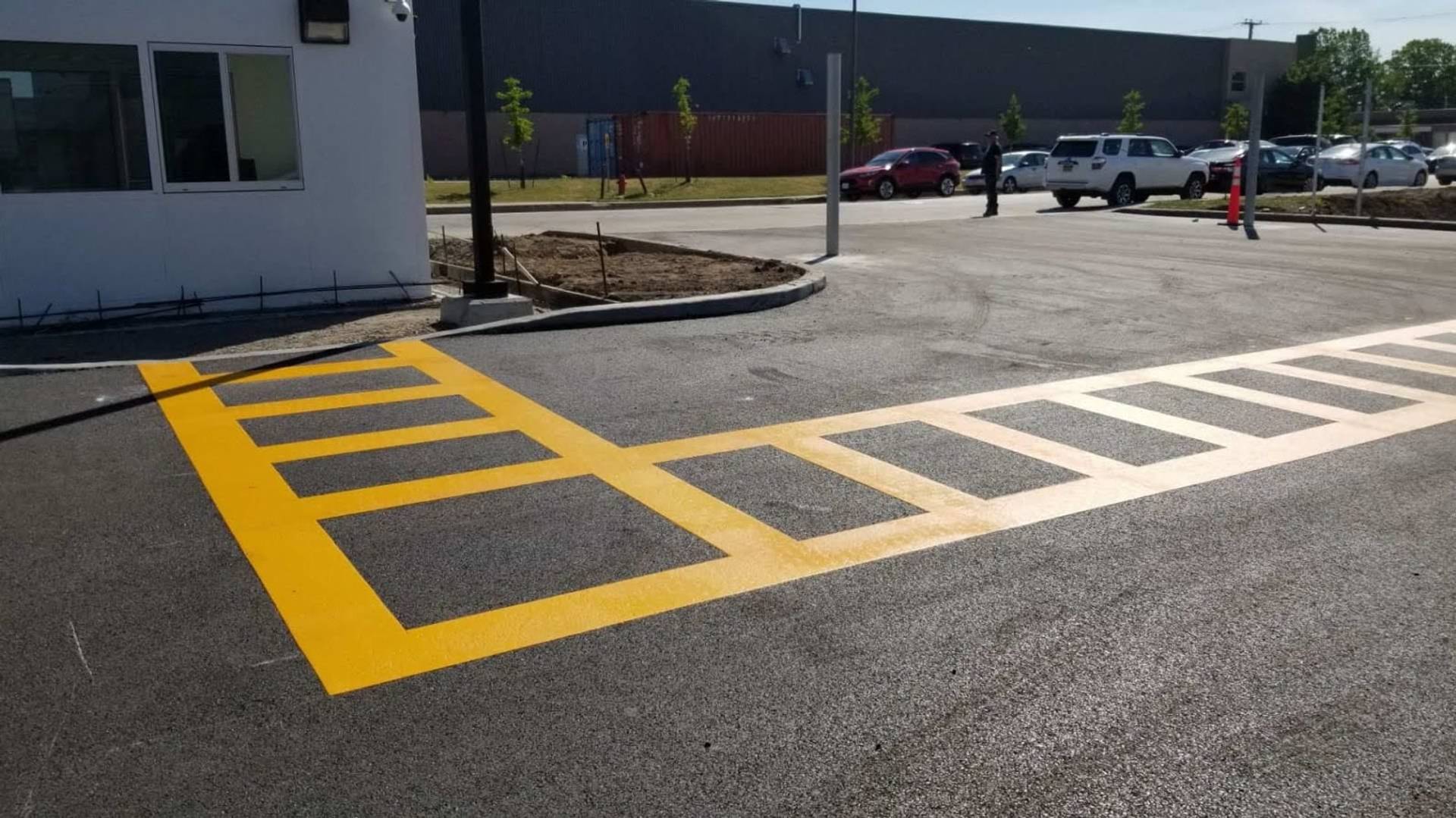 Parking lot line marking specified for stall layout and accessible parking at an office campus lot