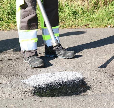 HUB Surface Systems ChipFill pavement repair: crack and chip repair in asphalt at a roadway repair