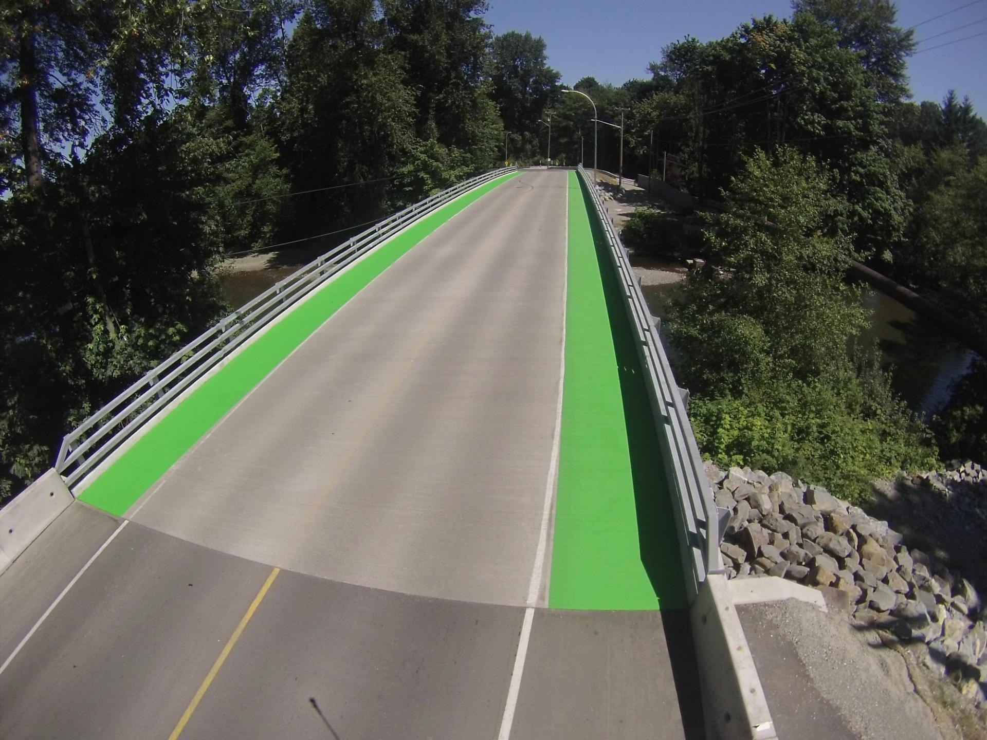 Coloured bike lane specified for protected cycling infrastructure at an intersection conflict zone