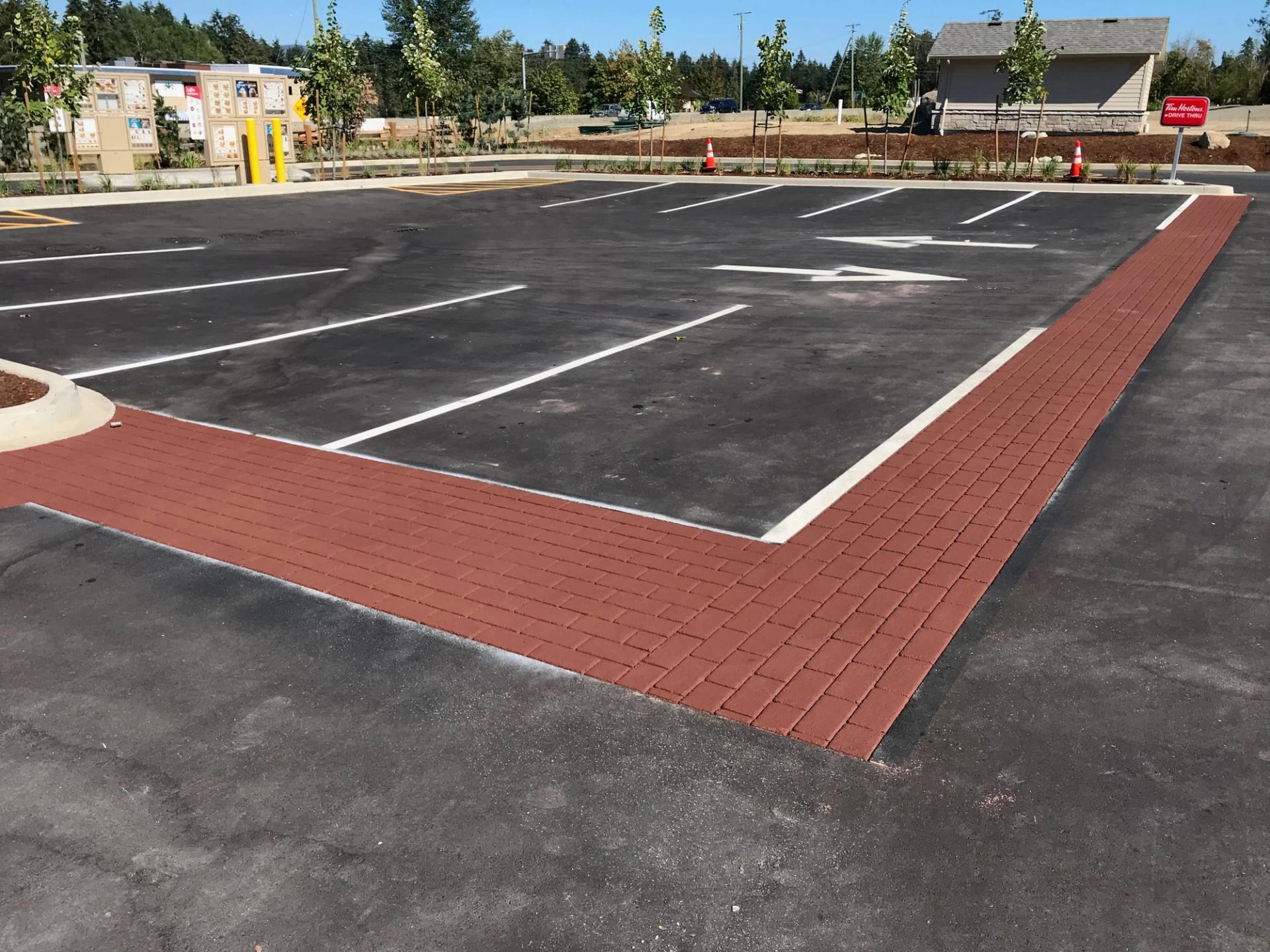 Red StreetPrint brick-pattern walkway edging a freshly lined parking lot