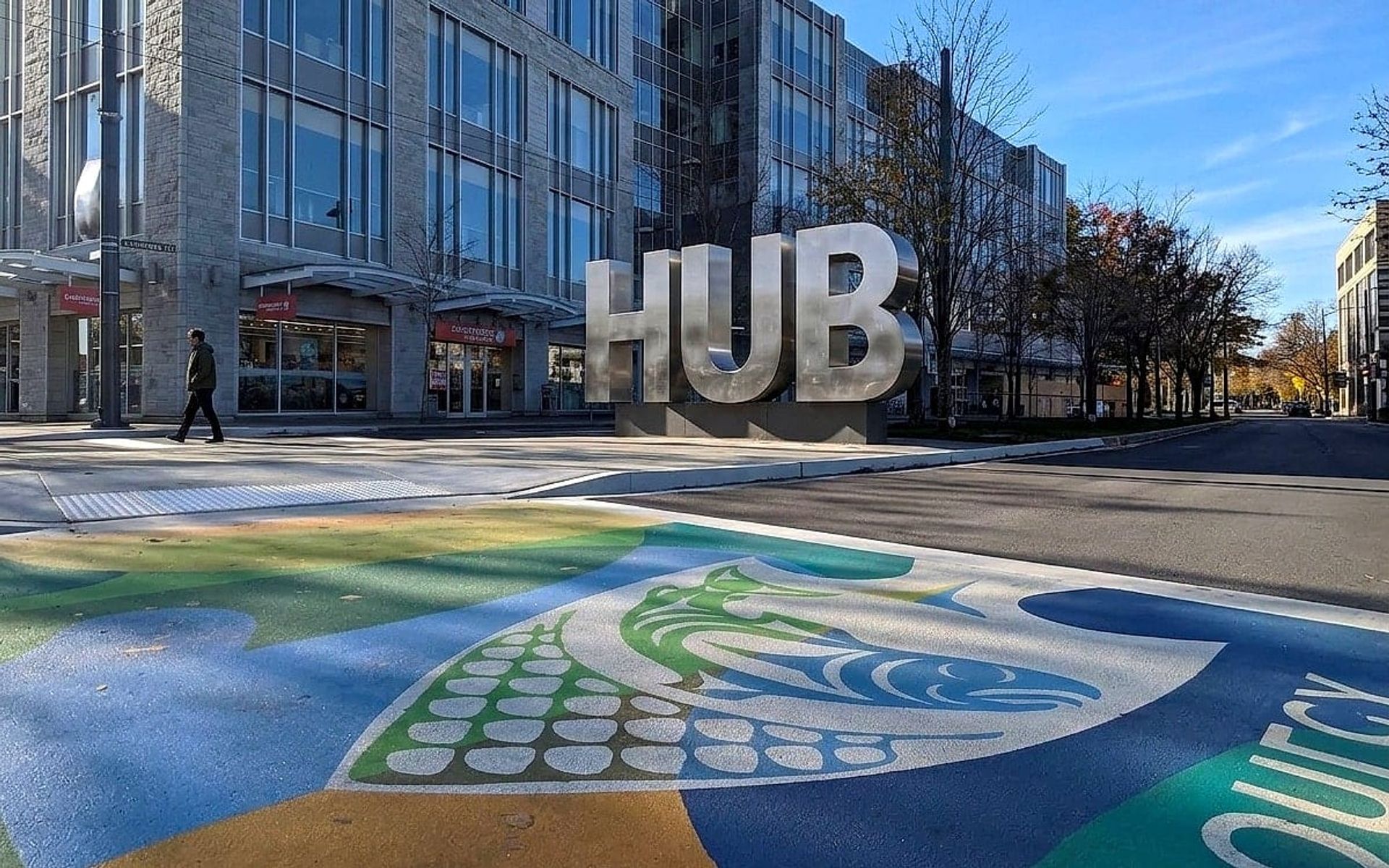The UBC Musqueam crosswalk at the University of British Columbia campus entrance in Vancouver: Coast Salish artwork rendered in coloured pavement by HUB Surface Systems