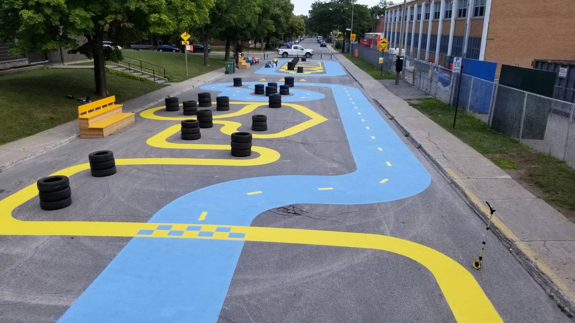 Playground surface graphics in coloured pavement coating and preformed play graphics at a daycare courtyard, Canada