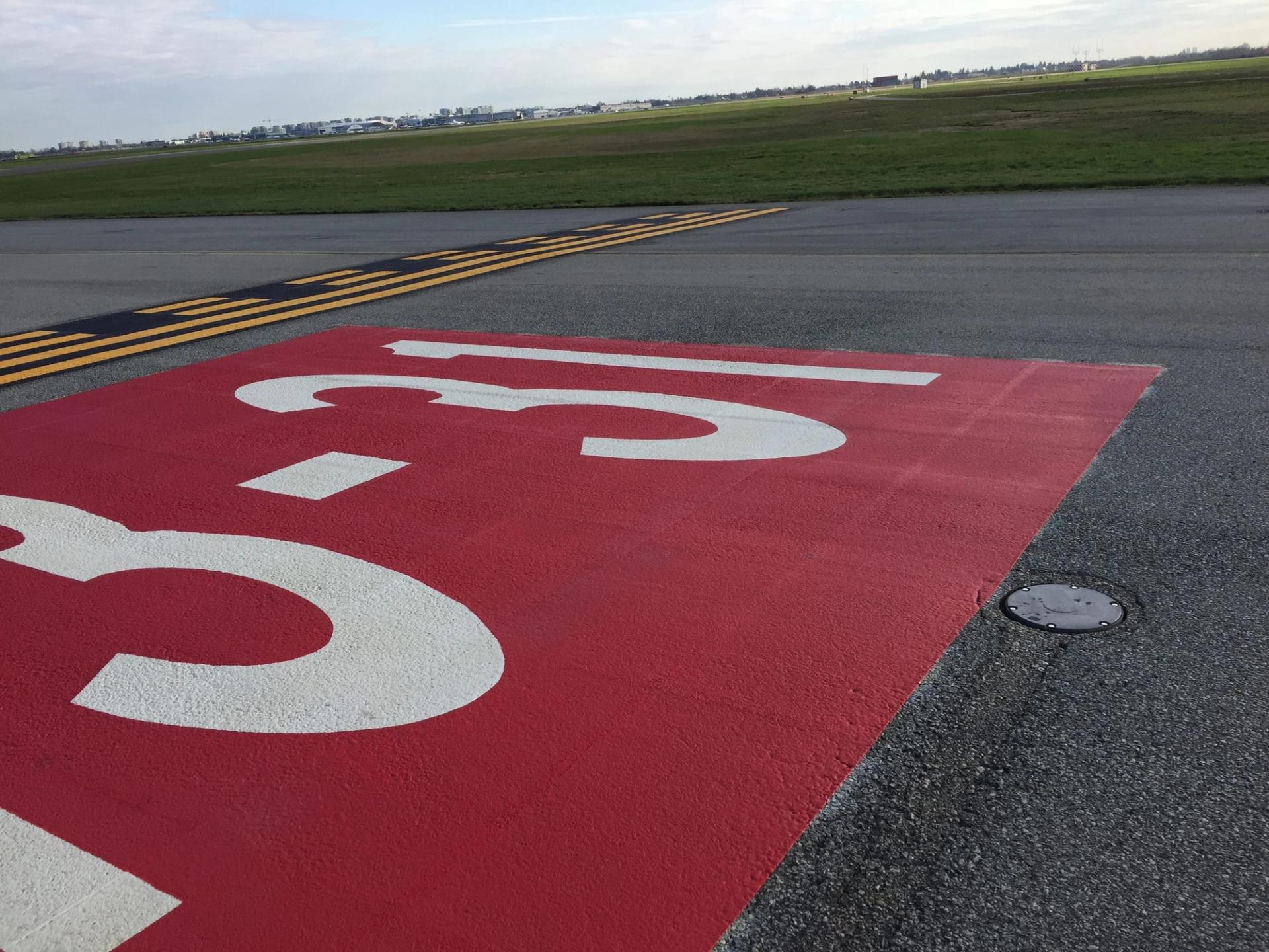 Airport pavement marking specified for apron and airside service area marking at an airside service road