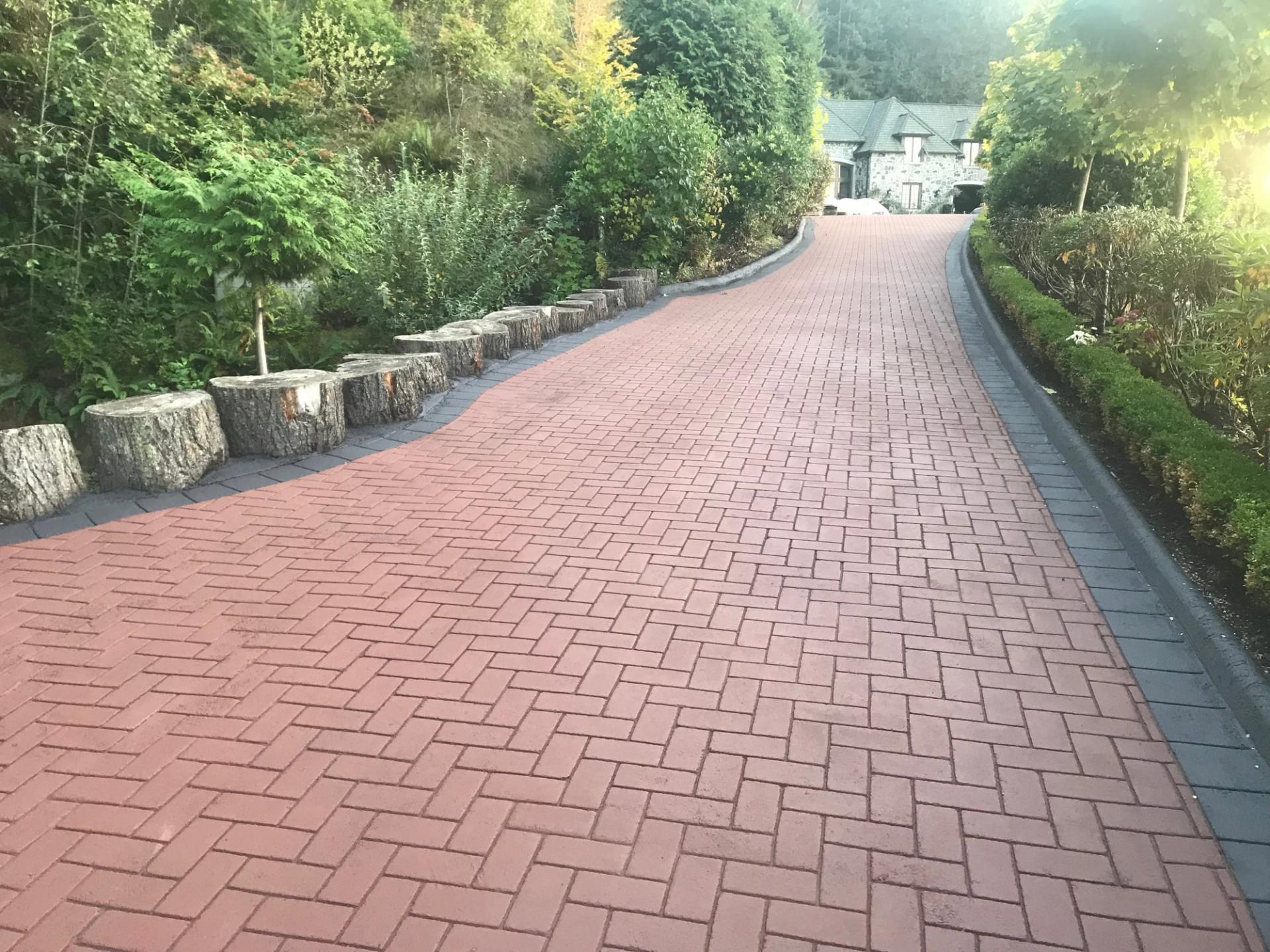 Stamped asphalt driveway specified for driveway surfacing with a paver appearance at a residential street frontage