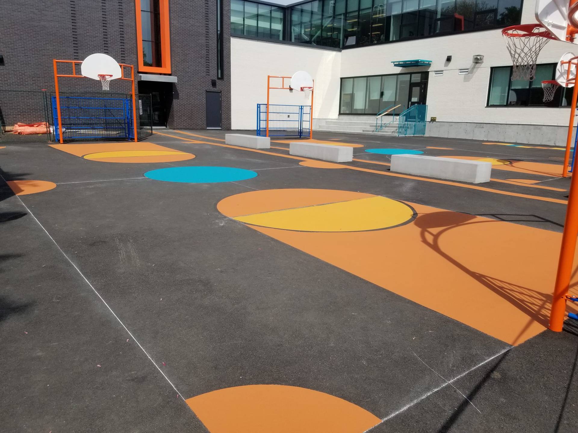 Sport court surfacing in coloured acrylic sport surface coating at a school basketball court, Canada