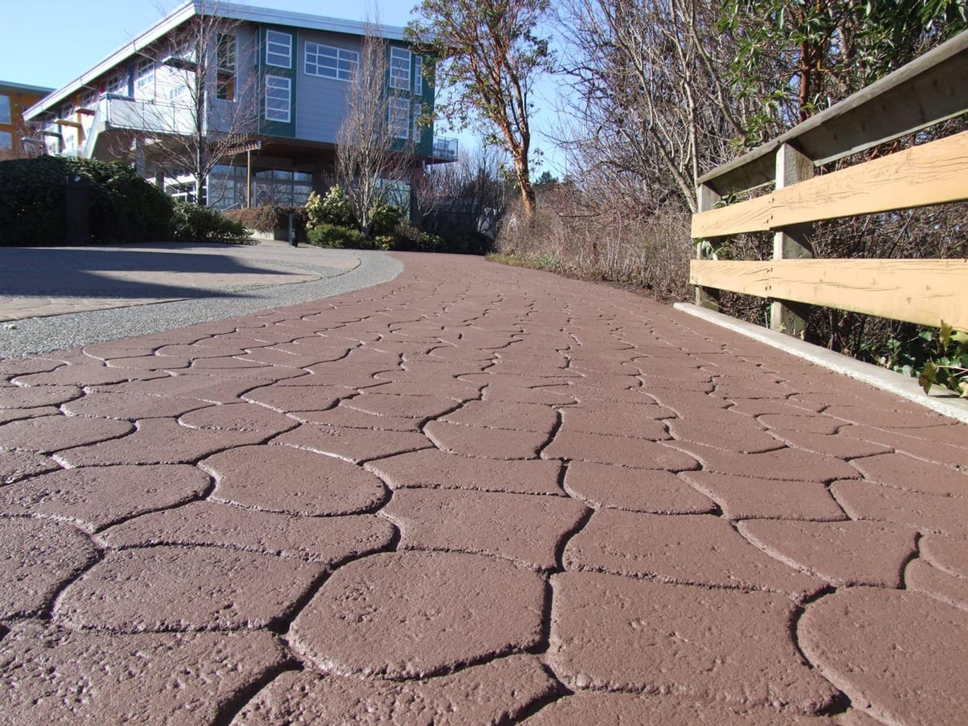 Why Stamped Asphalt Driveways Outperform Interlocking Stone (And Look Better Too)