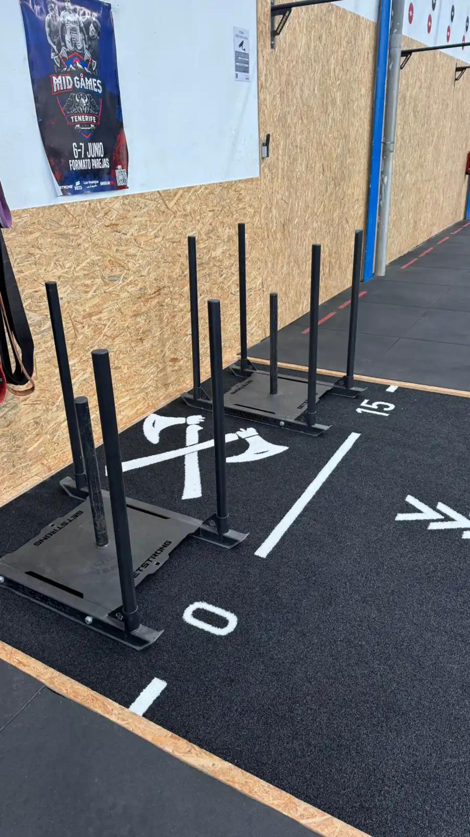 Training sled on the black Valhalla track at Midgard, with distance numbering and the crossed-axe motif on the surface
