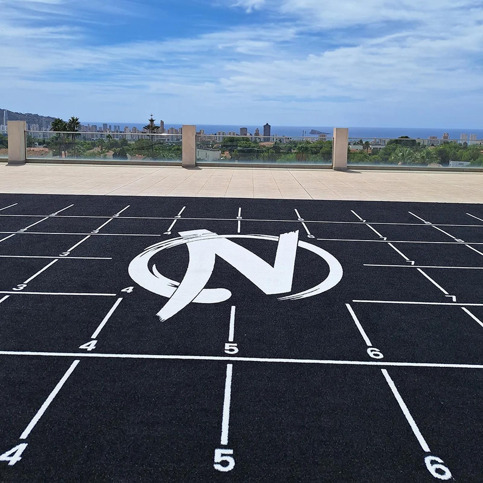 Close-up of the grid markings and Zeta logo on the outdoor black training area