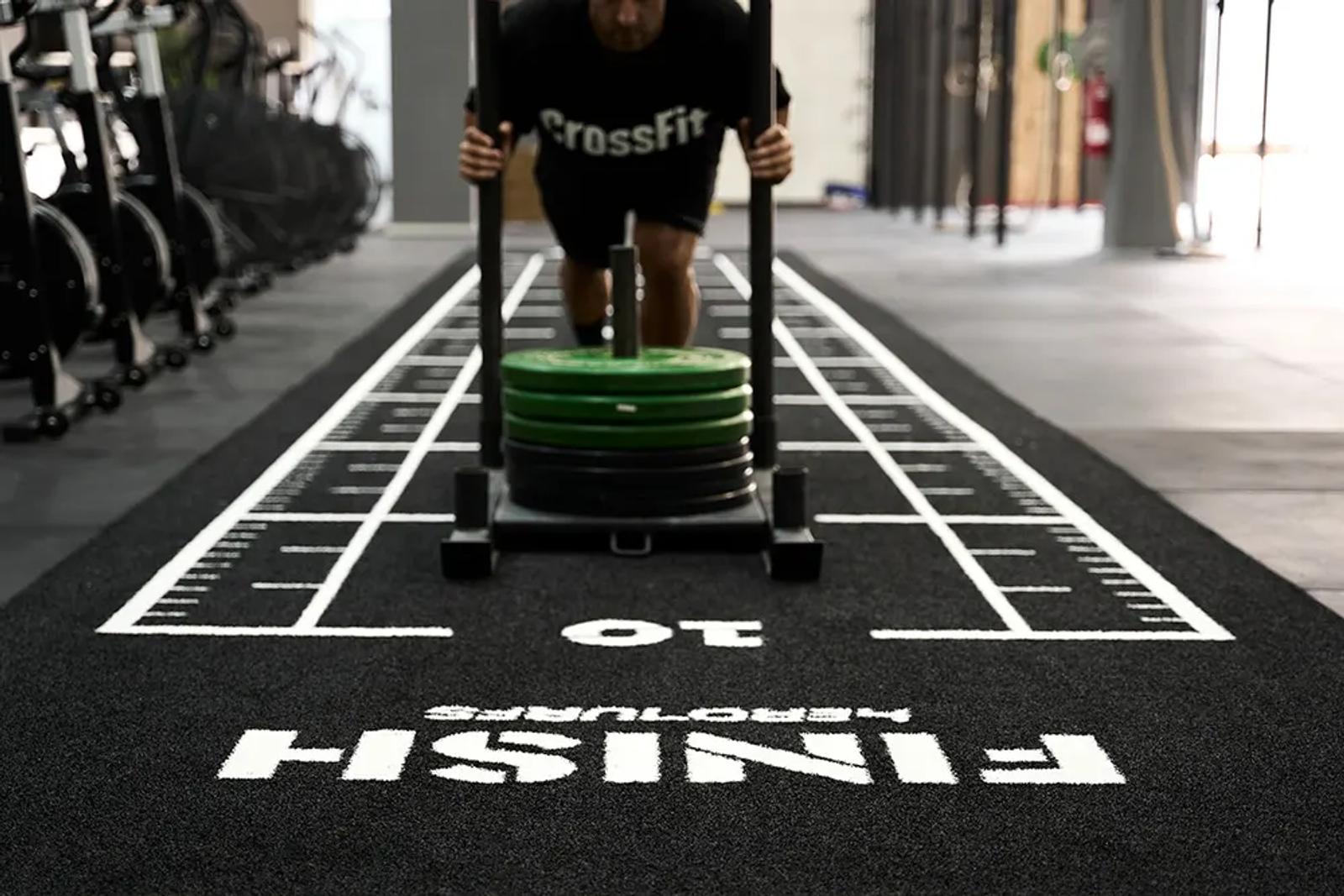 Athlete training on the numbered sled track inside the SFC CrossFit box, Llinars del Vallès