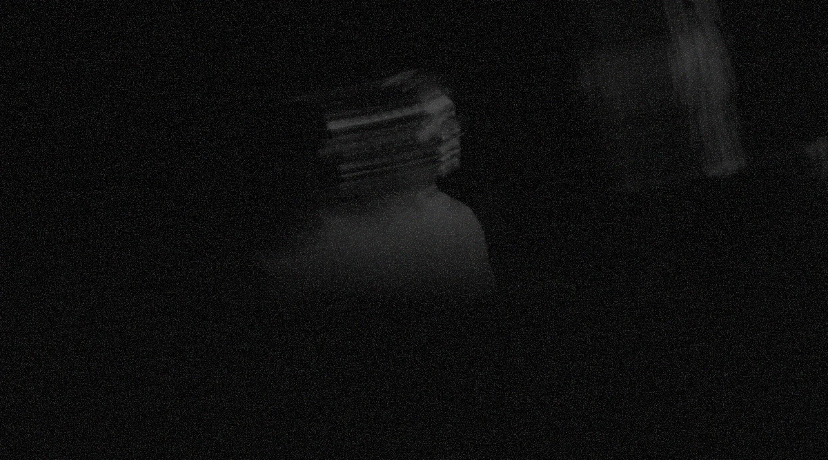 Dark, motion-blurred silhouette of a person