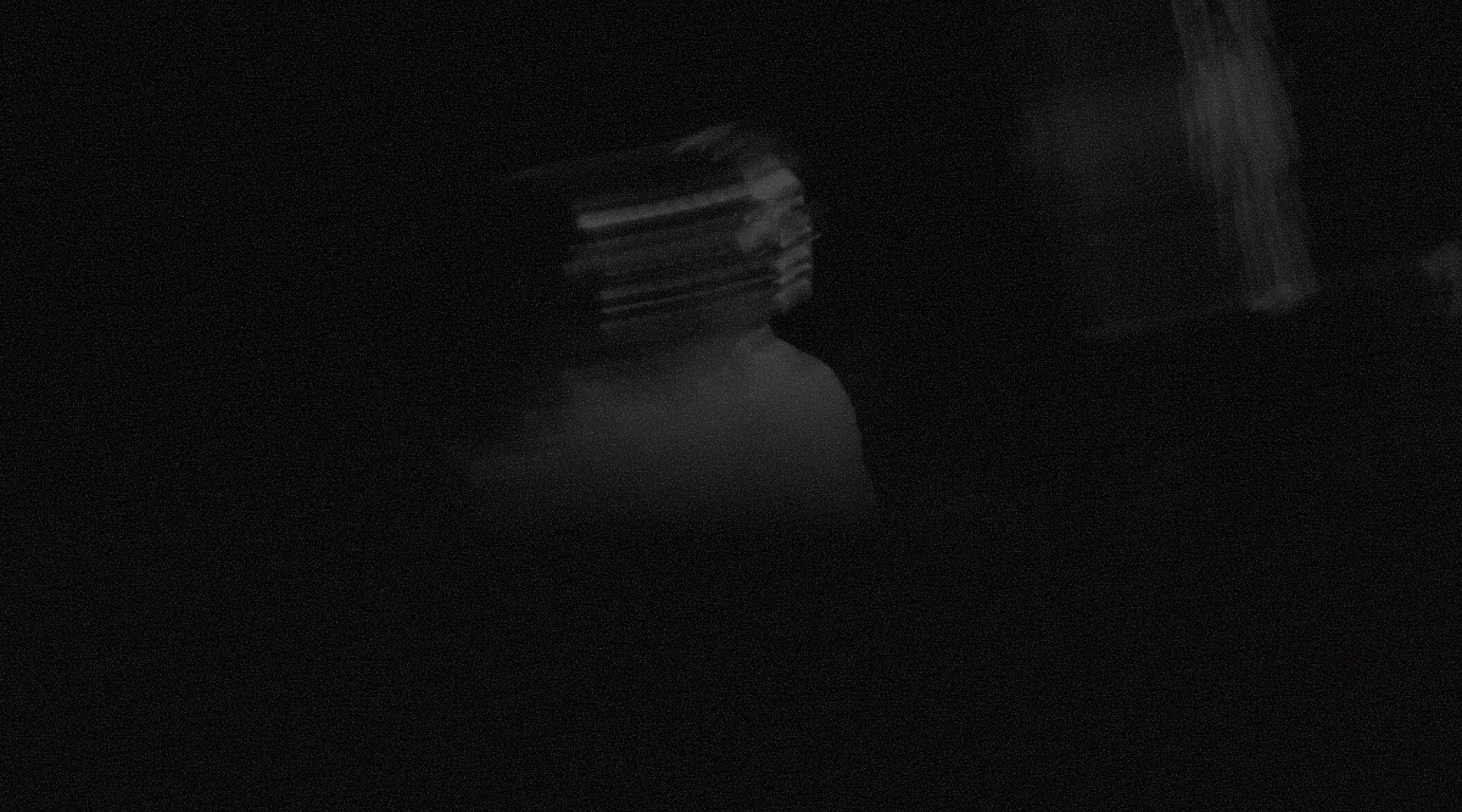 Dark, motion-blurred silhouette of a person