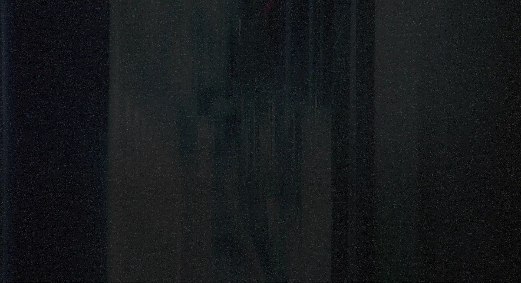 Dark, abstract vertical streaks and shadows creating a moody, low-light textured background