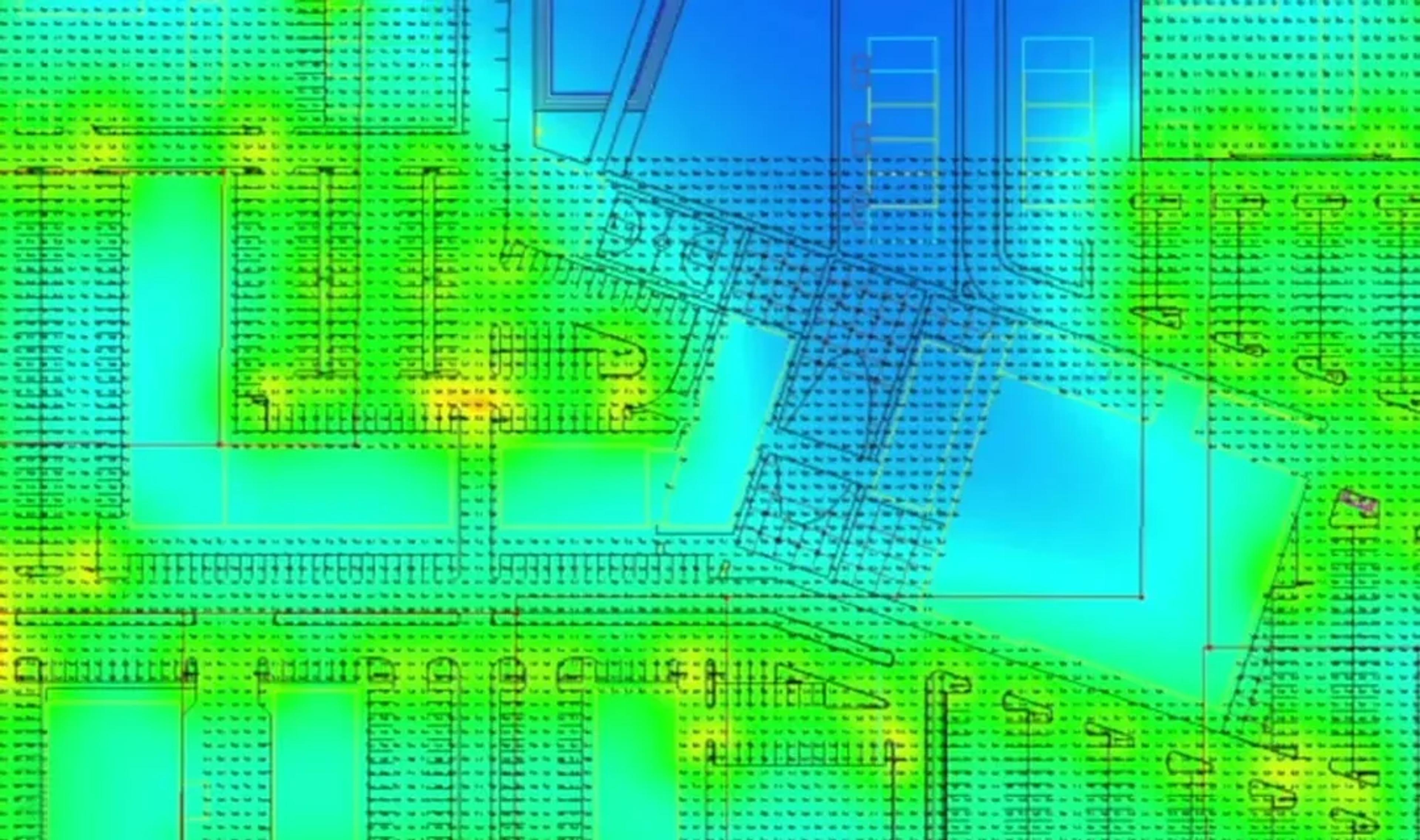 False-color photometric analysis rendering of a site lighting plan showing calculated illuminance levels across parking areas and buildings