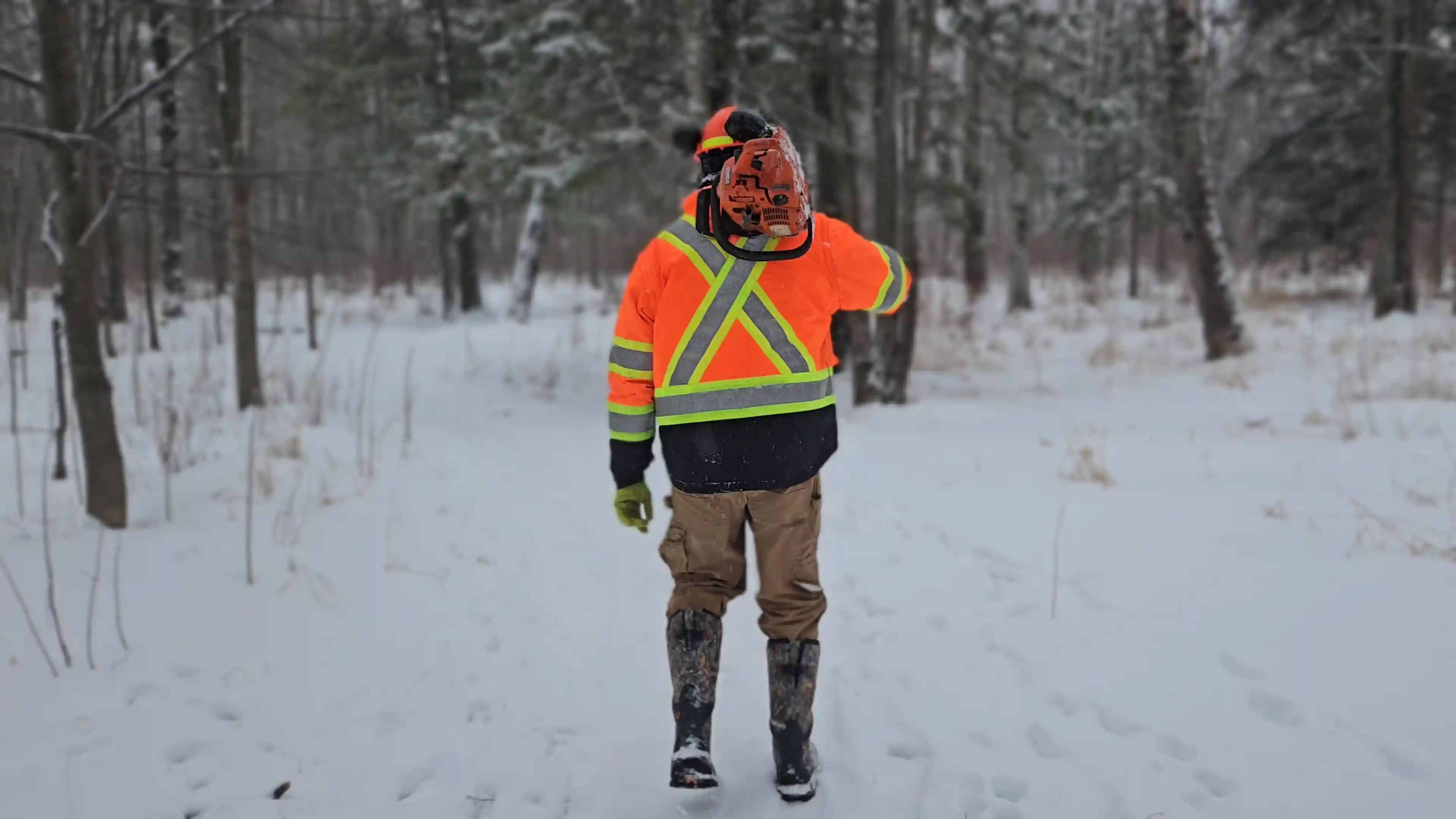 TULLOCH field technician carrying equipment during winter fieldwork.