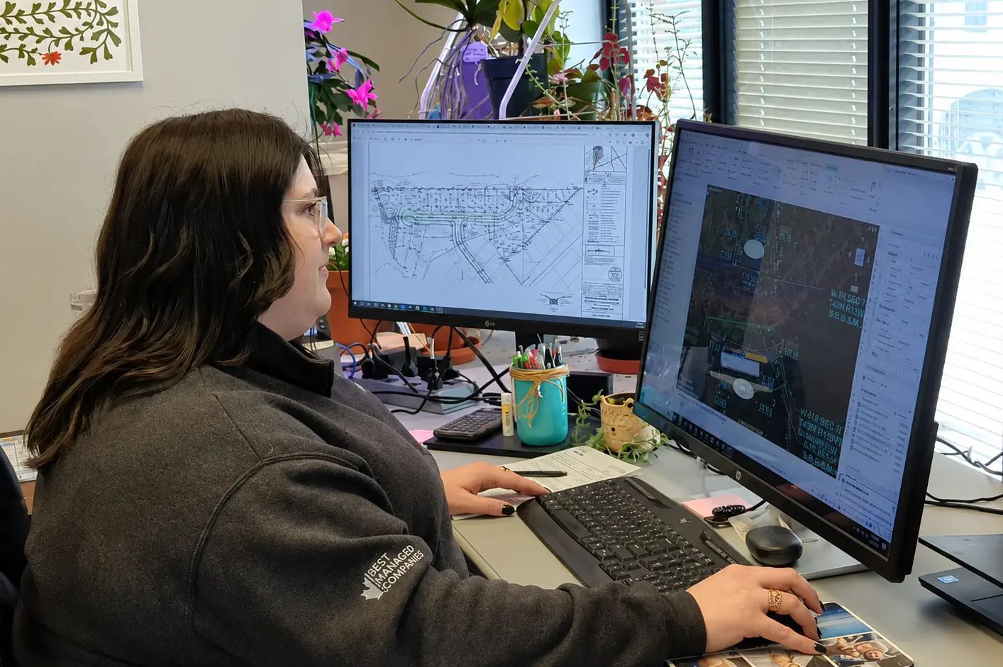 TULLOCH planner working with technical drawings at a computer.