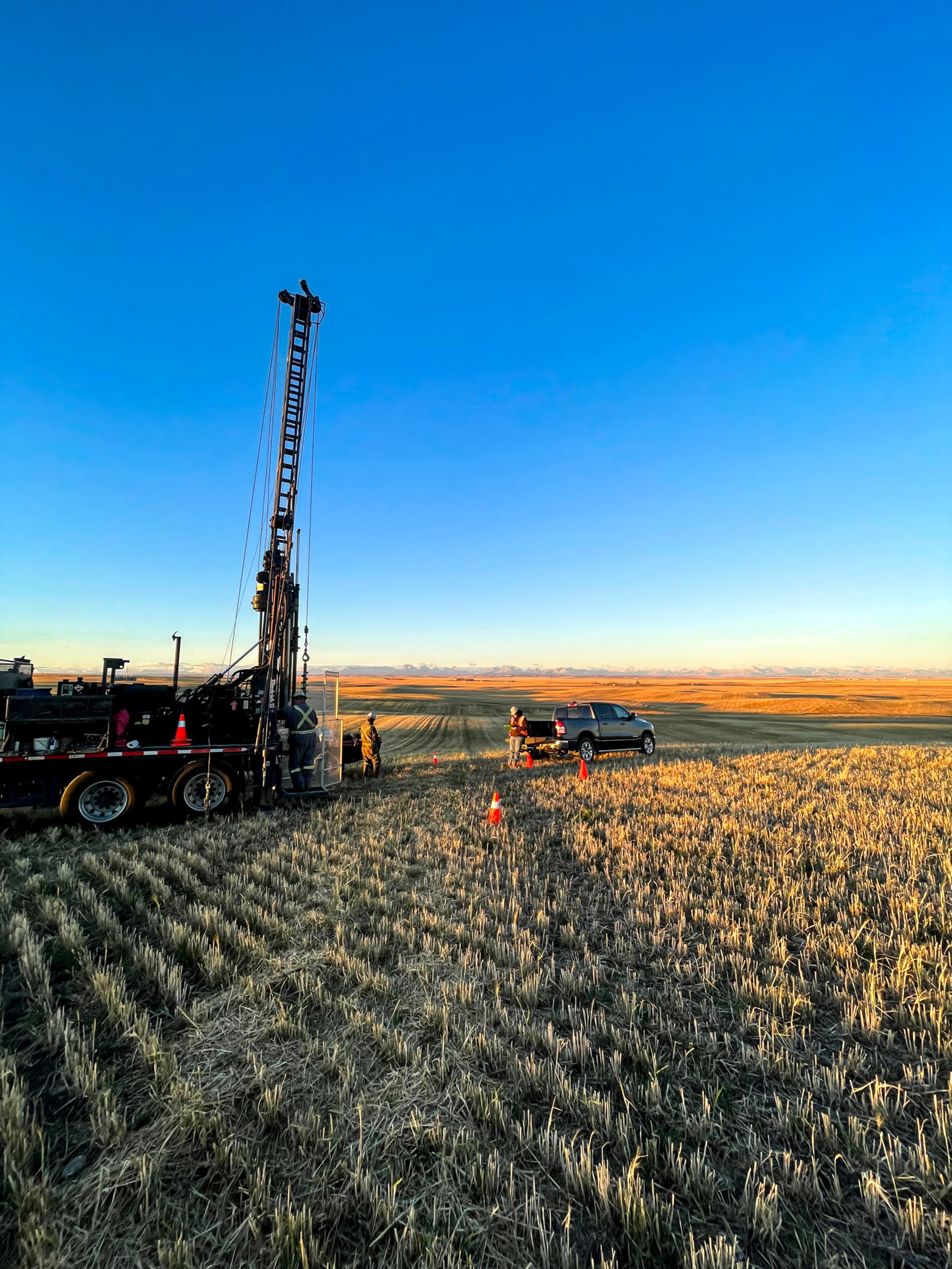 Drilling equipment operating across an open project site.