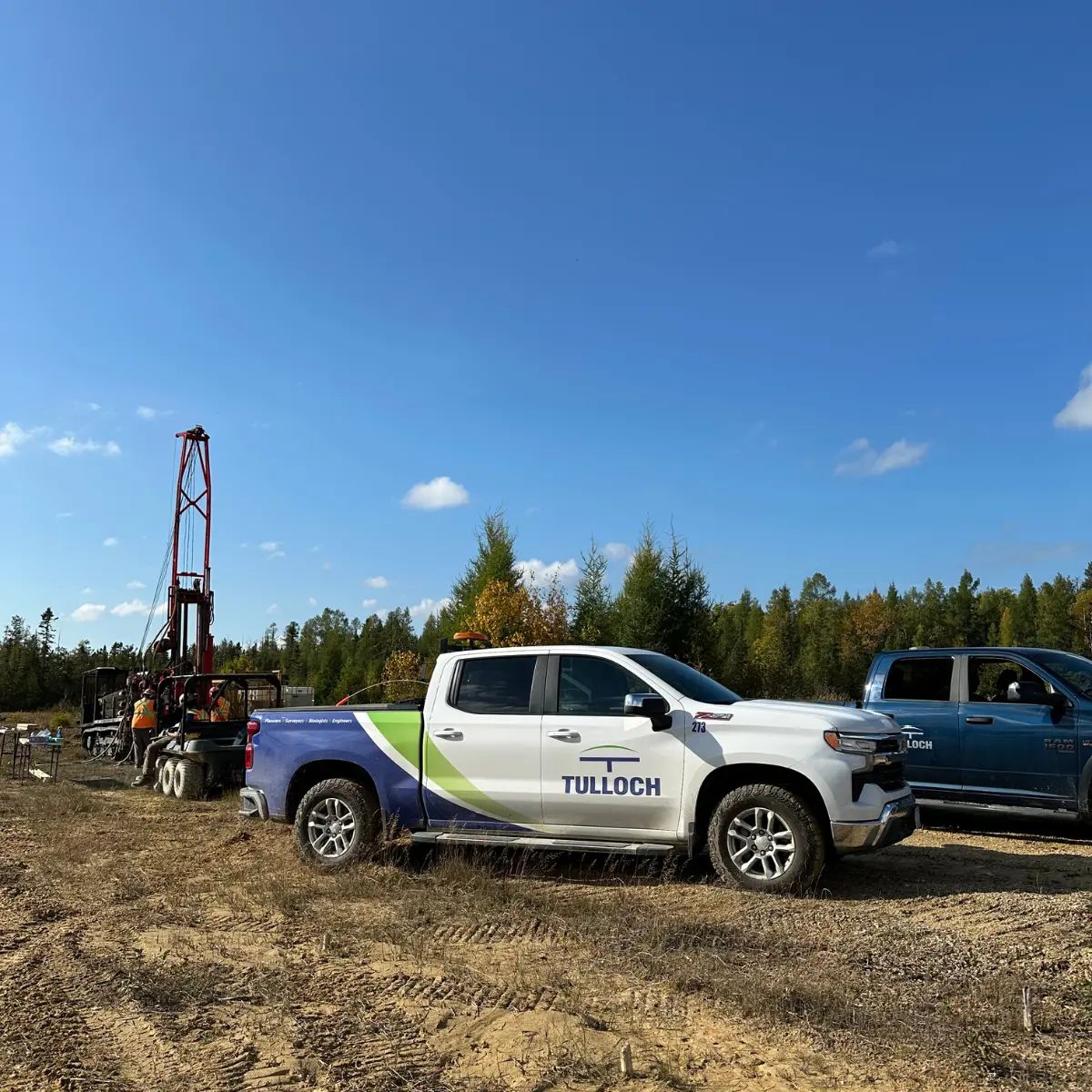TULLOCH truck beside geotechnical drilling equipment at a field site.