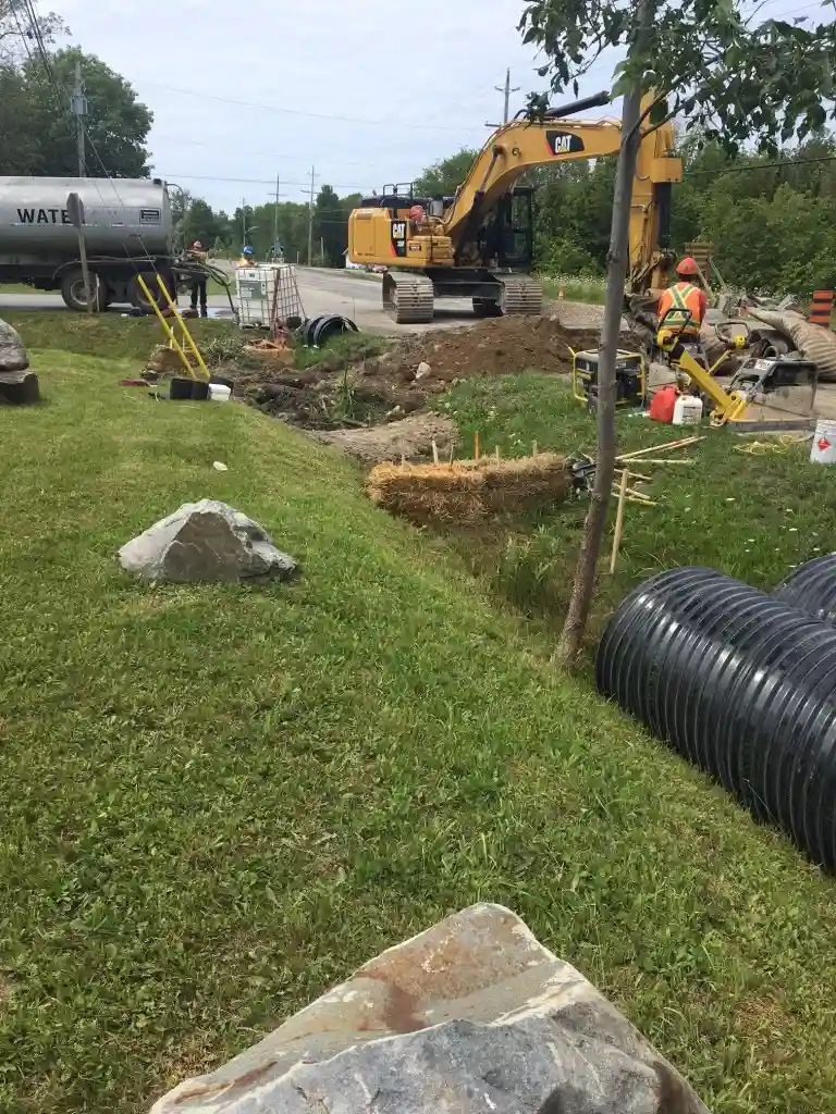 Construction crew installing drainage or culvert infrastructure.