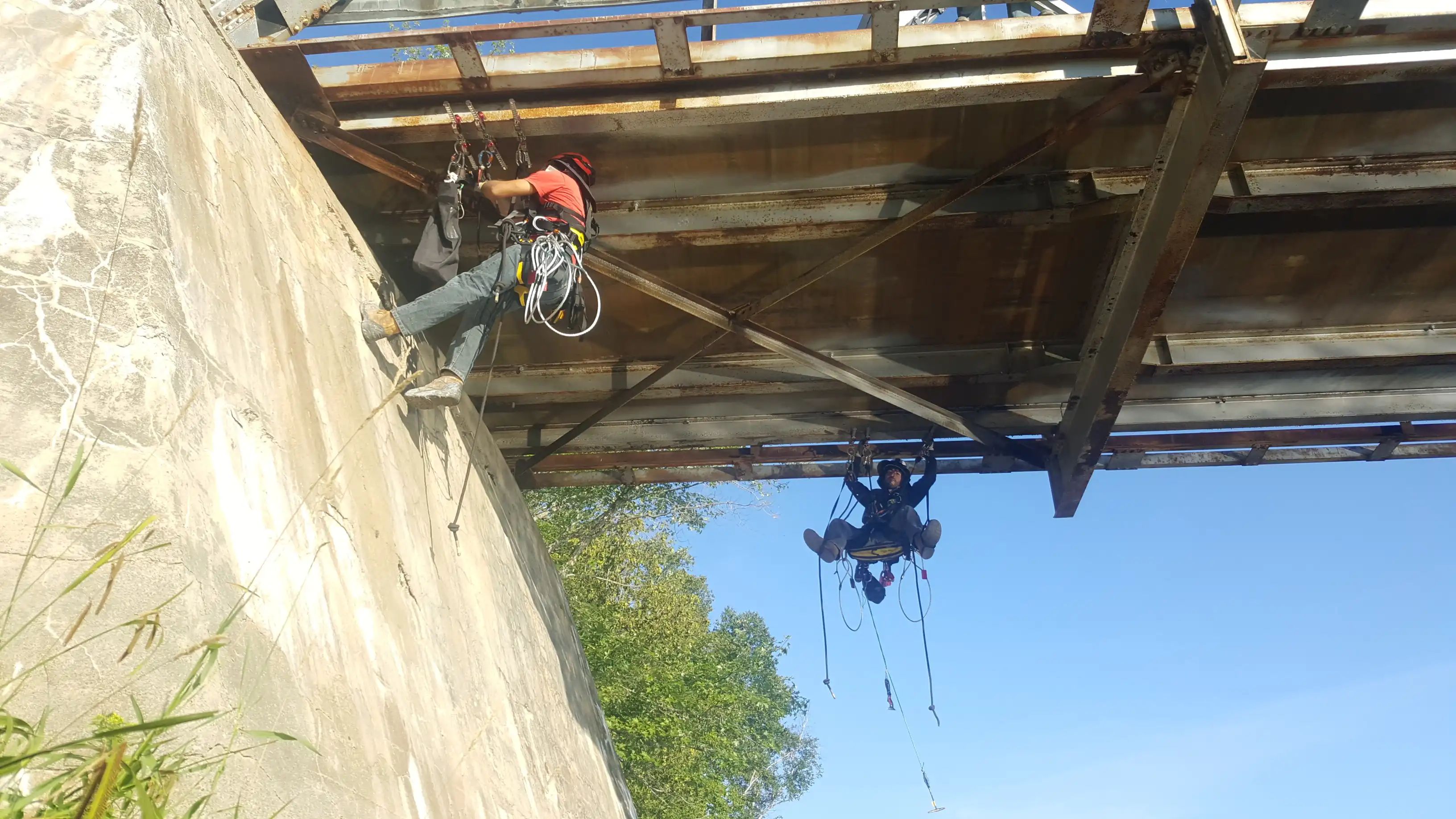 TULLOCH field staff inspecting conditions beneath a municipal bridge.