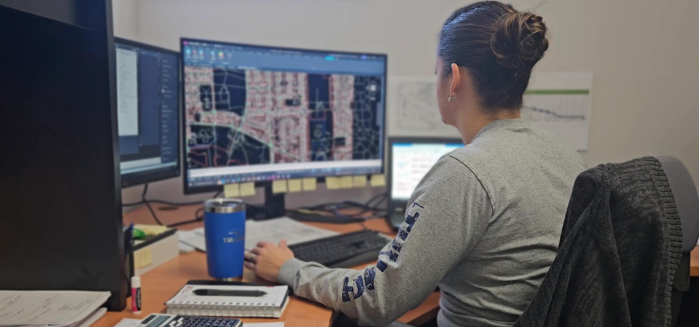 TULLOCH engineering team member reviewing project information at a workstation.