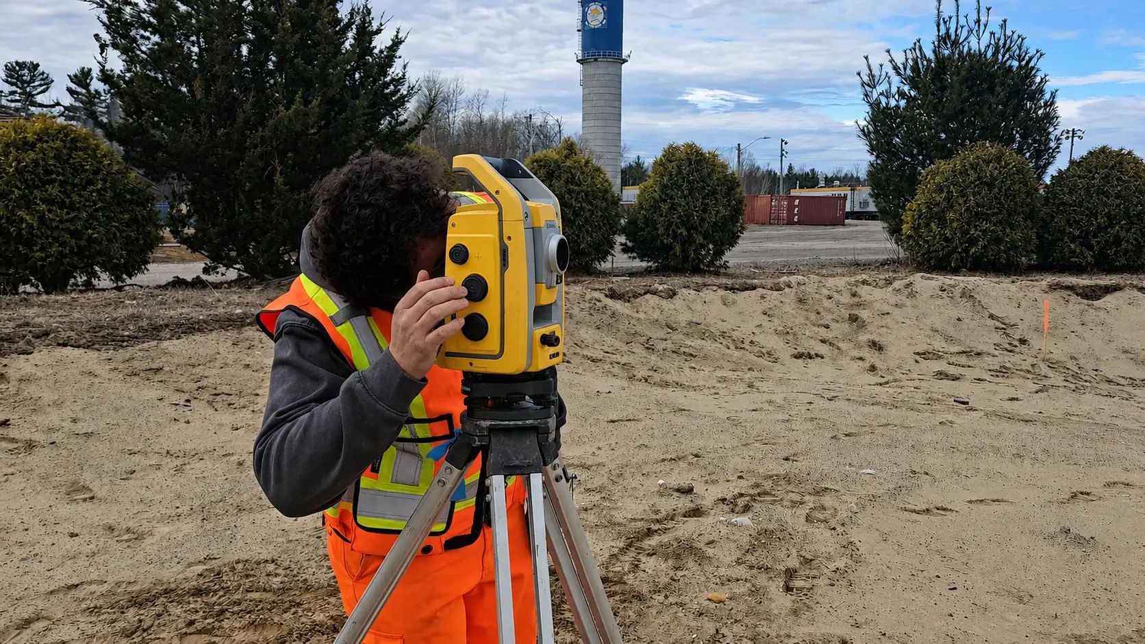 TULLOCH surveyor operating a total station at an industrial site.