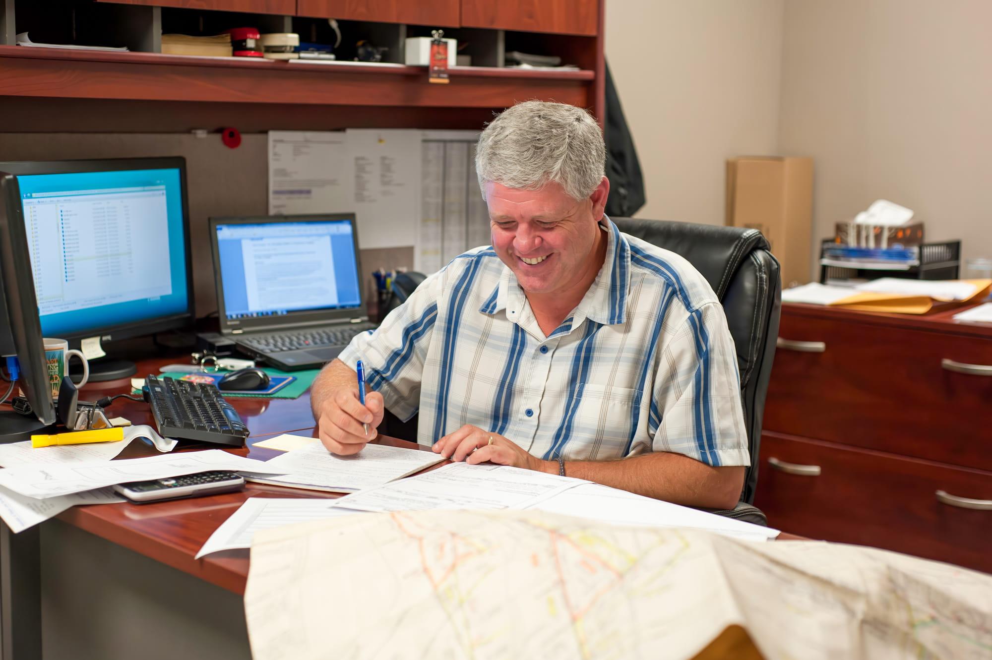 Experienced land surveyor reviewing drawings/