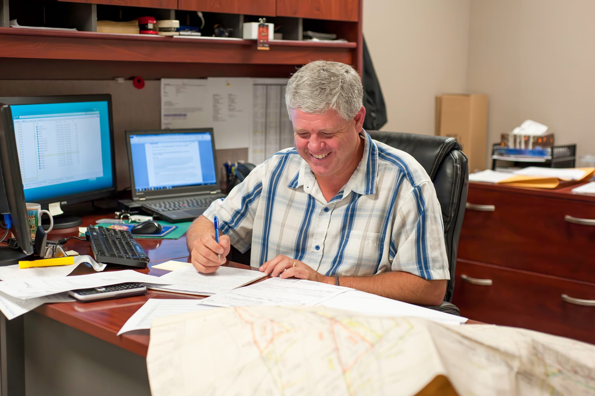 Experienced land surveyor reviewing drawings/