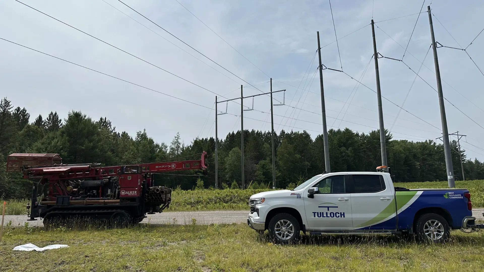 TULLOCH truck at transmission corridor project with geotechnical equipment.