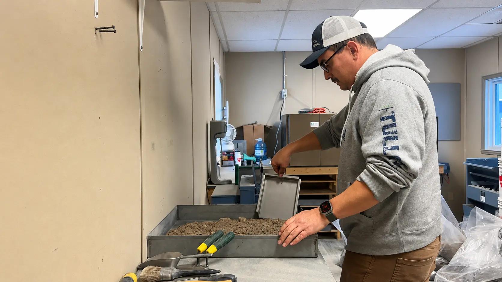 TULLOCH laboratory technician preparing sand for materials testing.