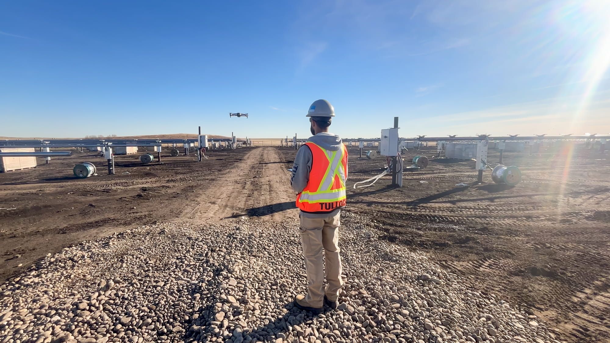 TULLOCH field technician collecting survey data at a solar project site.