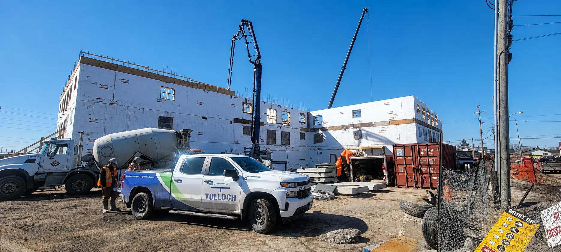 TULLOCH company truck at an active industrial construction site.