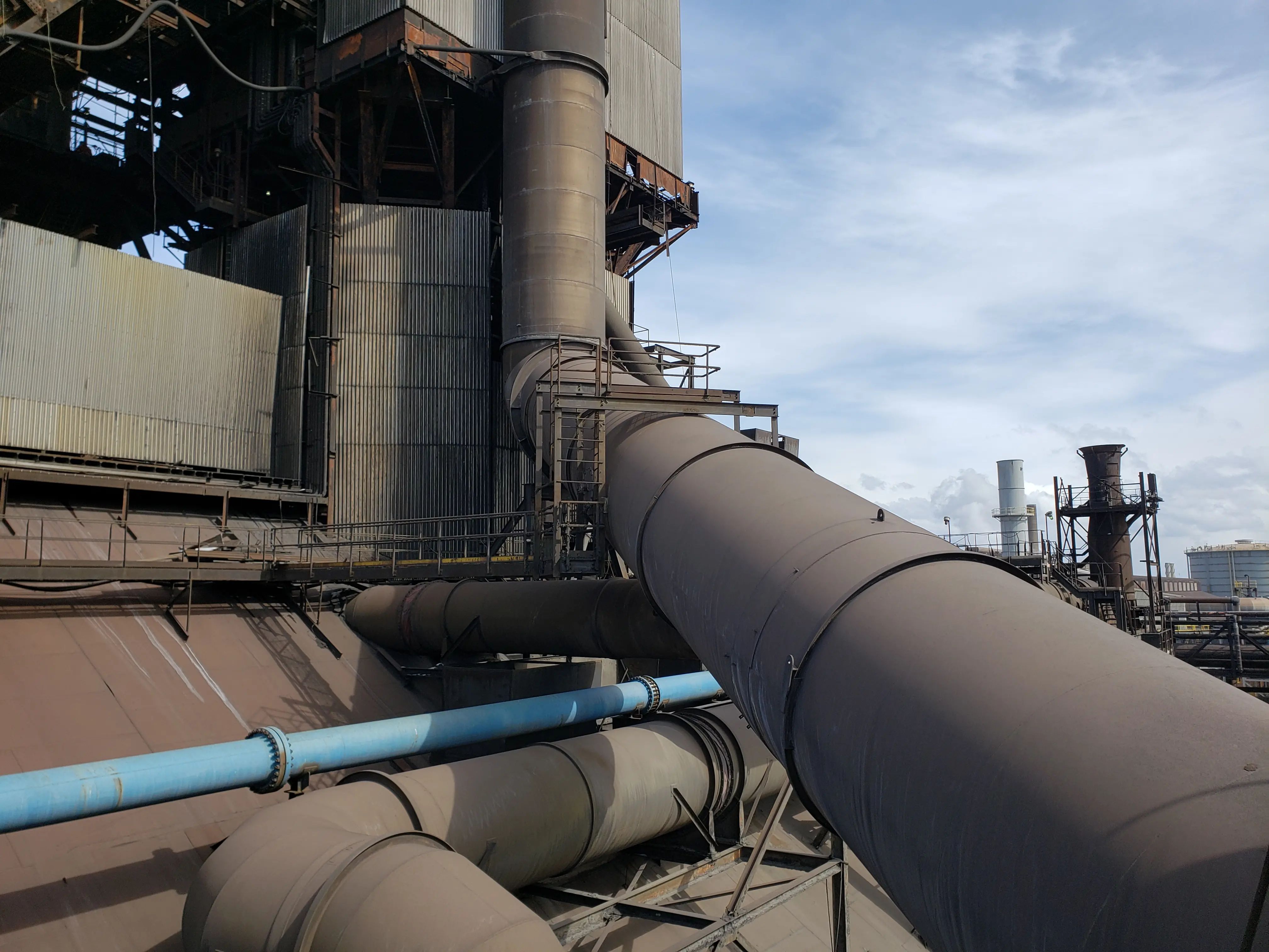 Large industrial riser main and connected piping at an operating facility.