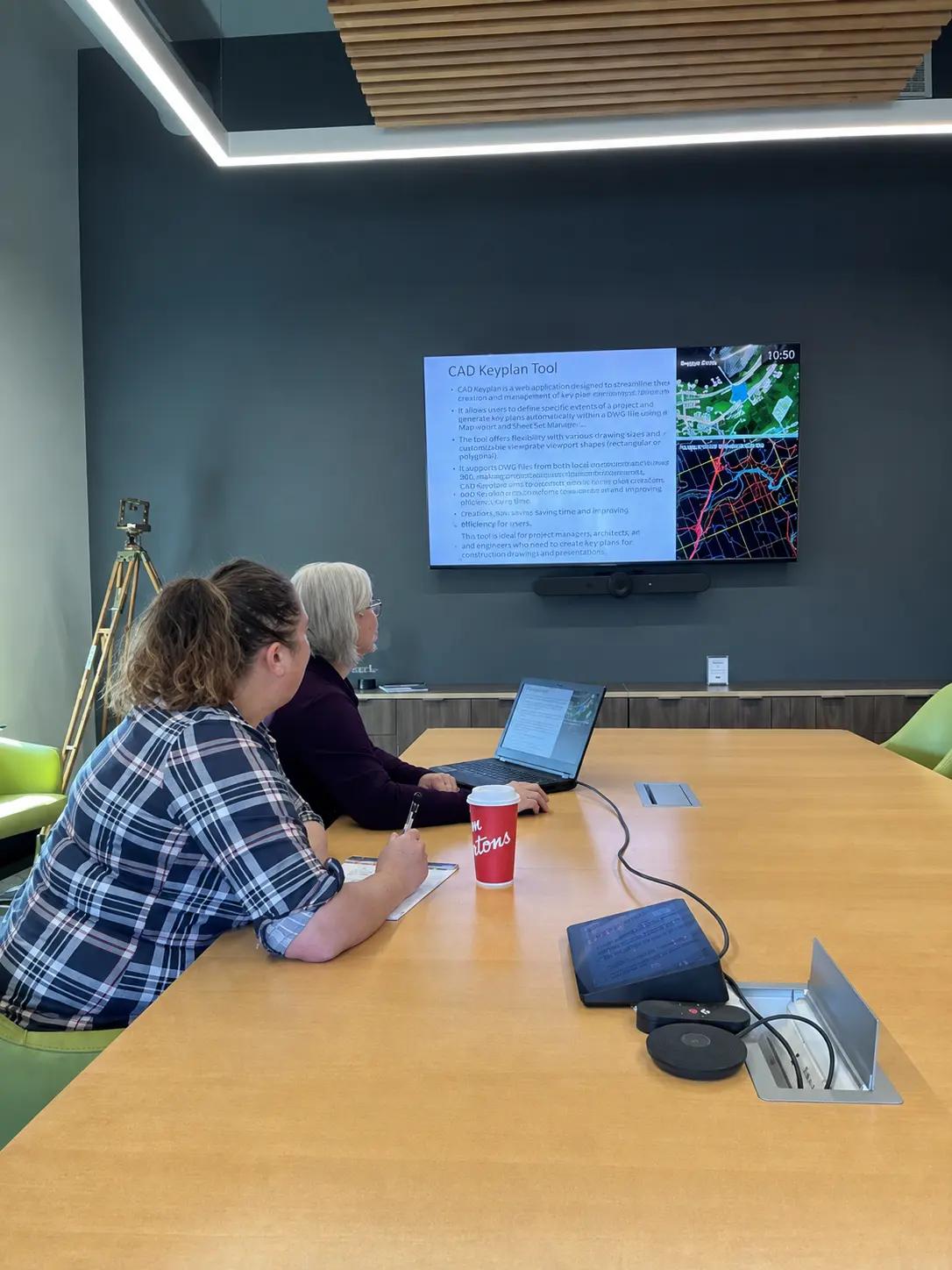 TULLOCH team members reviewing mapping information during a meeting.