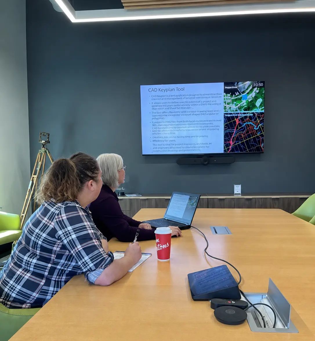 TULLOCH team members reviewing mapping information during a meeting.