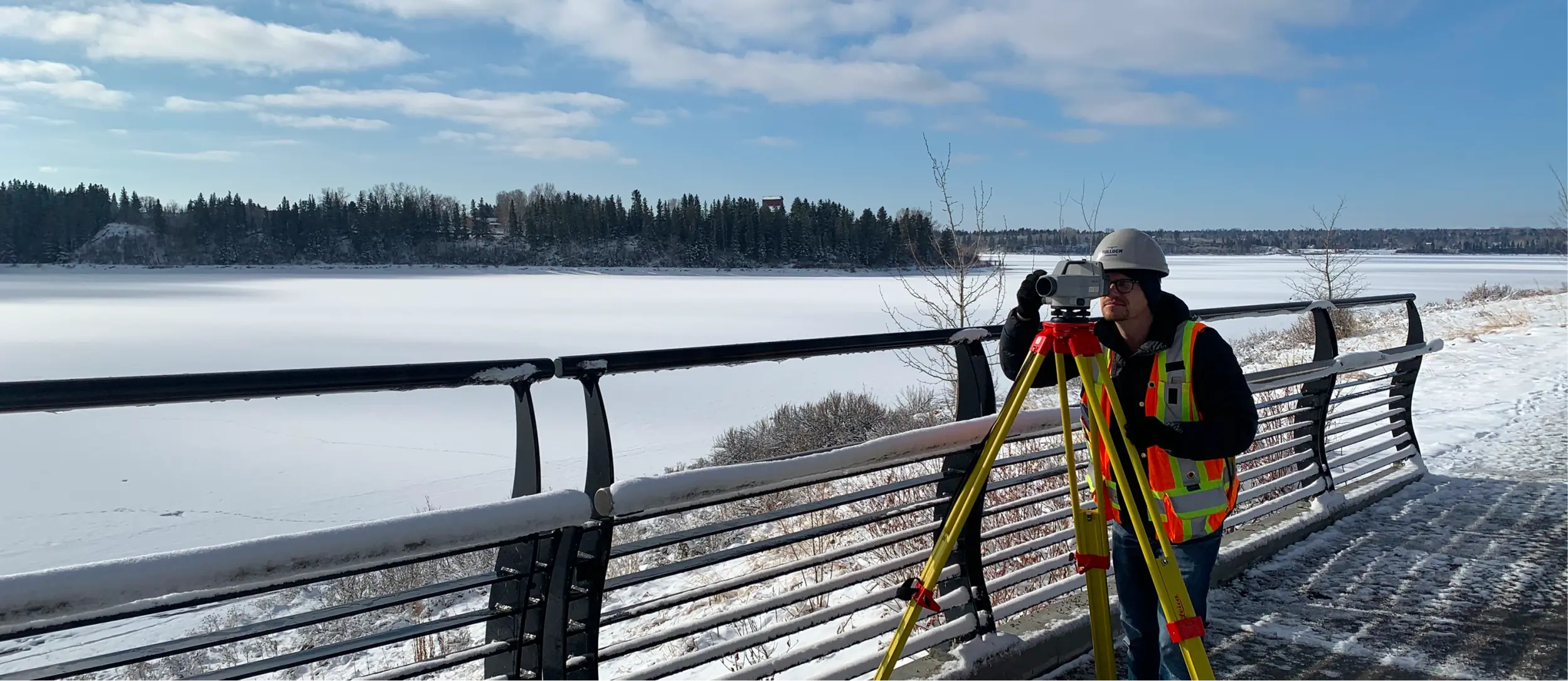 Alberta Land Surveyor doing levels and setting control.