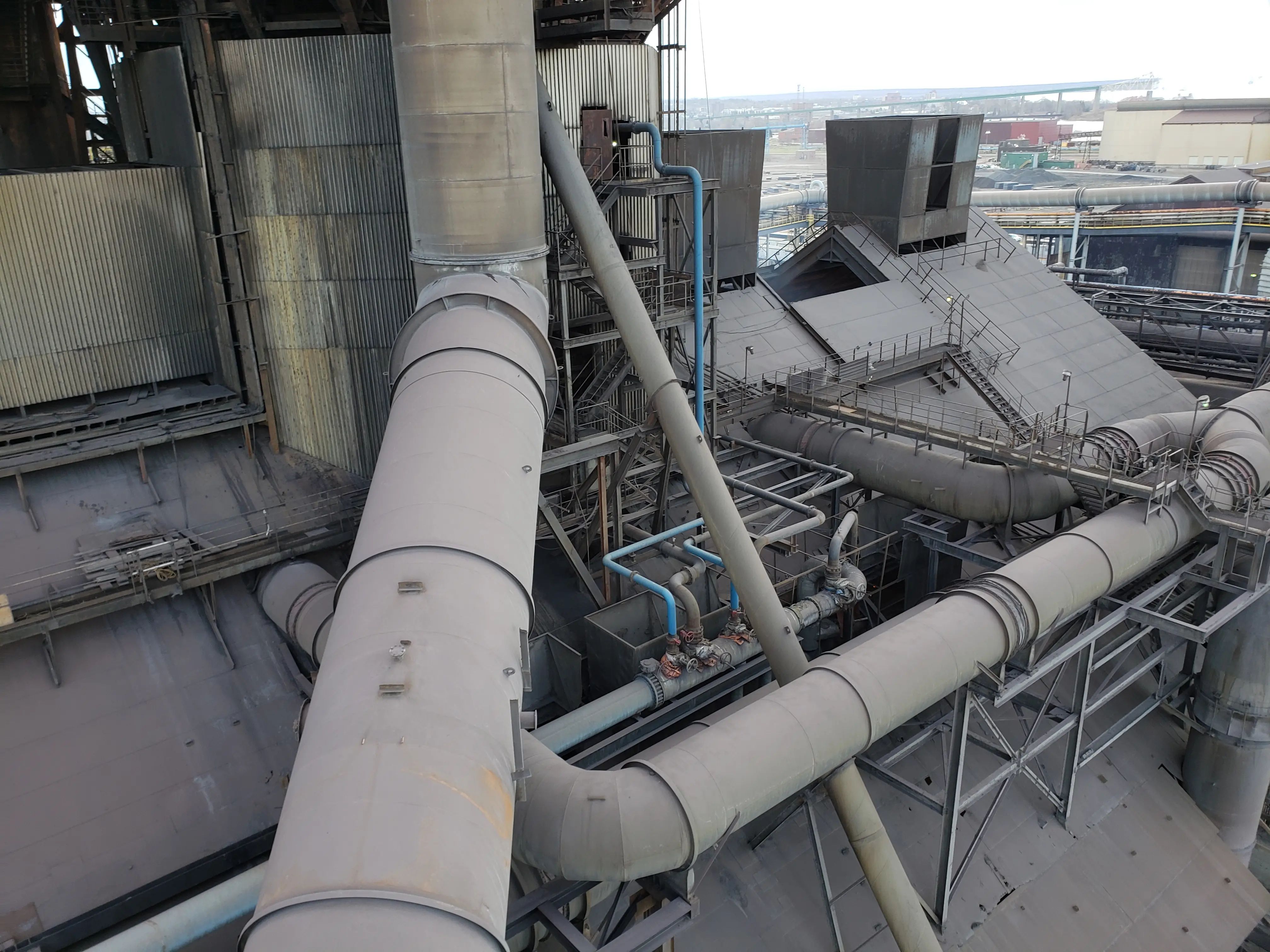 Existing riser main and surrounding industrial piping.